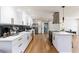 Modern kitchen features white cabinets, stainless steel appliances, and wood flooring at 14261 113Th Ave, Largo, FL 33774