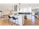 Modern kitchen features stainless steel appliances, a stylish island with seating, and updated white cabinets at 14261 113Th Ave, Largo, FL 33774