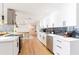 Bright open kitchen with modern white cabinets, quartz countertops, and eat-in island with stainless appliances at 14261 113Th Ave, Largo, FL 33774