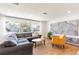 Comfortable living room featuring a gray sectional, yellow chair, and a decorative marble wall unit at 14261 113Th Ave, Largo, FL 33774