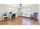 Bright office space featuring large windows, a desk with computer, and a comfortable rocking chair at 14261 113Th Ave, Largo, FL 33774