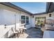 Relaxing outdoor patio area with modern seating and sliding glass door to the home's interior at 14261 113Th Ave, Largo, FL 33774