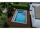 Aerial view of a modern pool with a sun deck and lush landscaping, ideal for relaxation and entertainment at 14261 113Th Ave, Largo, FL 33774