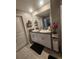 Bathroom featuring double sinks, granite counters, and modern fixtures at 16725 Delia St, Wimauma, FL 33598