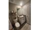 Bathroom featuring a toilet, sink, and cabinet at 16725 Delia St, Wimauma, FL 33598