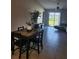 Dining area connected to living room, featuring a table with four chairs and neutral decor at 16725 Delia St, Wimauma, FL 33598