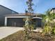 Inviting one-story home with a well-manicured lawn and covered entryway at 16725 Delia St, Wimauma, FL 33598