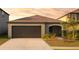 Charming one-story home with a two-car garage and well-maintained landscaping at 16725 Delia St, Wimauma, FL 33598