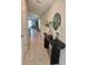 Hallway with view of living area and stylish console table at 16725 Delia St, Wimauma, FL 33598