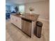 Granite kitchen island with sink and stainless steel dishwasher at 16725 Delia St, Wimauma, FL 33598