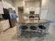 Bright kitchen island with barstool seating and granite countertops at 16725 Delia St, Wimauma, FL 33598