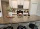 Spacious kitchen with a large island, granite countertops, and modern sink at 16725 Delia St, Wimauma, FL 33598