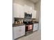 Kitchen with stainless steel appliances and white cabinets at 16725 Delia St, Wimauma, FL 33598