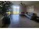 Well-lit living room featuring a comfortable gray sofa and a view of the water at 16725 Delia St, Wimauma, FL 33598