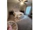 Comfortable bedroom featuring a bed, rug, and soft natural light at 16725 Delia St, Wimauma, FL 33598