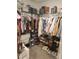 Walk-in closet featuring many clothes, shoes, and built in shelving at 16725 Delia St, Wimauma, FL 33598