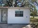 Up-close side exterior view of the home with visible address number and a closed front door at 1716 Lancelot Loop, Tampa, FL 33619