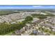 Wide aerial view of the community, including lakes, community pool, and surrounding greenery at 1767 Tonka Ter, Wesley Chapel, FL 33543