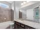 Secondary bathroom with a tiled shower/tub and vanity with granite counters at 1767 Tonka Ter, Wesley Chapel, FL 33543