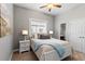Bedroom with stylish wood accent wall, neutral carpet, and bright window at 1767 Tonka Ter, Wesley Chapel, FL 33543