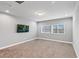 Bedroom featuring carpet, two windows, and a TV at 1767 Tonka Ter, Wesley Chapel, FL 33543