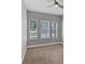 Bright bedroom showcasing three large windows that let in ample natural light at 1767 Tonka Ter, Wesley Chapel, FL 33543