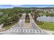 Community entrance over the water via unique wooden bridge with landscaped median at 1767 Tonka Ter, Wesley Chapel, FL 33543