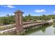 Community entrance over the water via unique wooden bridge with a tower at 1767 Tonka Ter, Wesley Chapel, FL 33543