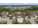 Stunning aerial view of the community center and pool area, surrounded by palm trees and lush landscaping at 1767 Tonka Ter, Wesley Chapel, FL 33543