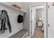 Entryway featuring a bench, storage, and access to a bedroom with wood accent wall at 1767 Tonka Ter, Wesley Chapel, FL 33543