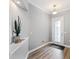 Inviting entryway with decorative front door, a plant, and wood-look flooring at 1767 Tonka Ter, Wesley Chapel, FL 33543