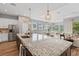 Bright, open kitchen with stainless steel appliances, granite counters, and center island, great for cooking at 1767 Tonka Ter, Wesley Chapel, FL 33543