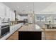 Modern kitchen featuring granite countertops, stainless steel appliances, a large island, and pendant lighting at 1767 Tonka Ter, Wesley Chapel, FL 33543