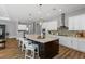 Bright kitchen with granite countertops, stainless steel appliances, custom backsplash, and a large central island at 1767 Tonka Ter, Wesley Chapel, FL 33543
