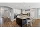 Charming kitchen with granite countertops, white cabinetry, stainless steel appliances, and a breakfast bar at 1767 Tonka Ter, Wesley Chapel, FL 33543