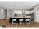 Beautiful kitchen with granite counters, white cabinets, stainless appliances, and a large center island with seating at 1767 Tonka Ter, Wesley Chapel, FL 33543