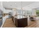 Spacious kitchen boasts a large island, stainless steel appliances, granite counters, and an open floor plan at 1767 Tonka Ter, Wesley Chapel, FL 33543