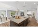 Open kitchen with granite counters, stainless appliances, and island, perfect for entertaining guests at 1767 Tonka Ter, Wesley Chapel, FL 33543