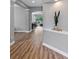 Open-concept living area featuring wood floors and archways leading to other rooms at 1767 Tonka Ter, Wesley Chapel, FL 33543
