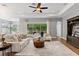 Spacious living room with a ceiling fan and sliding glass doors opening to a green and private backyard at 1767 Tonka Ter, Wesley Chapel, FL 33543