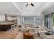 Bright and airy open-concept living space with modern finishes, hardwood floors, and comfortable seating areas at 1767 Tonka Ter, Wesley Chapel, FL 33543