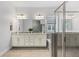 Bathroom with double vanity, soaking tub, and walk-in shower, designed for relaxation and convenience at 1767 Tonka Ter, Wesley Chapel, FL 33543