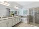 Bathroom featuring double sinks, soaking tub, and walk-in shower for a luxurious spa experience at 1767 Tonka Ter, Wesley Chapel, FL 33543