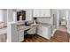 A stylish office nook with built-in cabinets, granite countertops, hardwood floors, and a comfortable chair at 1767 Tonka Ter, Wesley Chapel, FL 33543