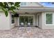 Covered patio with stamped concrete, ceiling fan, TV, and outdoor seating area at 1767 Tonka Ter, Wesley Chapel, FL 33543