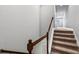 Carpeted staircase with white railings and a wood handrail leading upstairs at 1767 Tonka Ter, Wesley Chapel, FL 33543