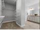 Walk-in closet featuring wire shelving and neutral carpeting connecting to the primary bathroom at 1767 Tonka Ter, Wesley Chapel, FL 33543