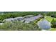 Aerial view of light blue townhomes next to a pond and a green golf course at 18148 Nassau Point Dr, Tampa, FL 33647