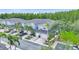Aerial view of blue townhomes with attached garages, sidewalks and palm trees at 18148 Nassau Point Dr, Tampa, FL 33647