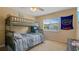 Bright bedroom featuring an ample amount of closet space, a desk, and a bunk bed at 18148 Nassau Point Dr, Tampa, FL 33647